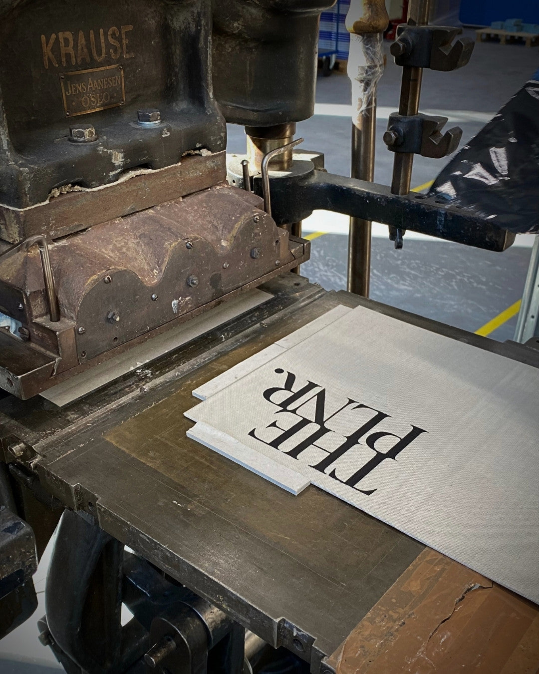 Vintage printing press with the linen cloth cover and THE PLNR logo. The PLNR in the making in Norway.